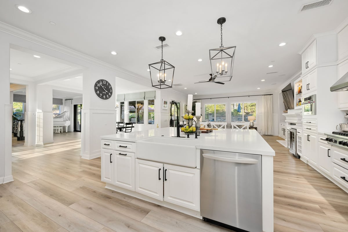 A bright and elegant open-concept living space with a modern kitchen in a luxury home