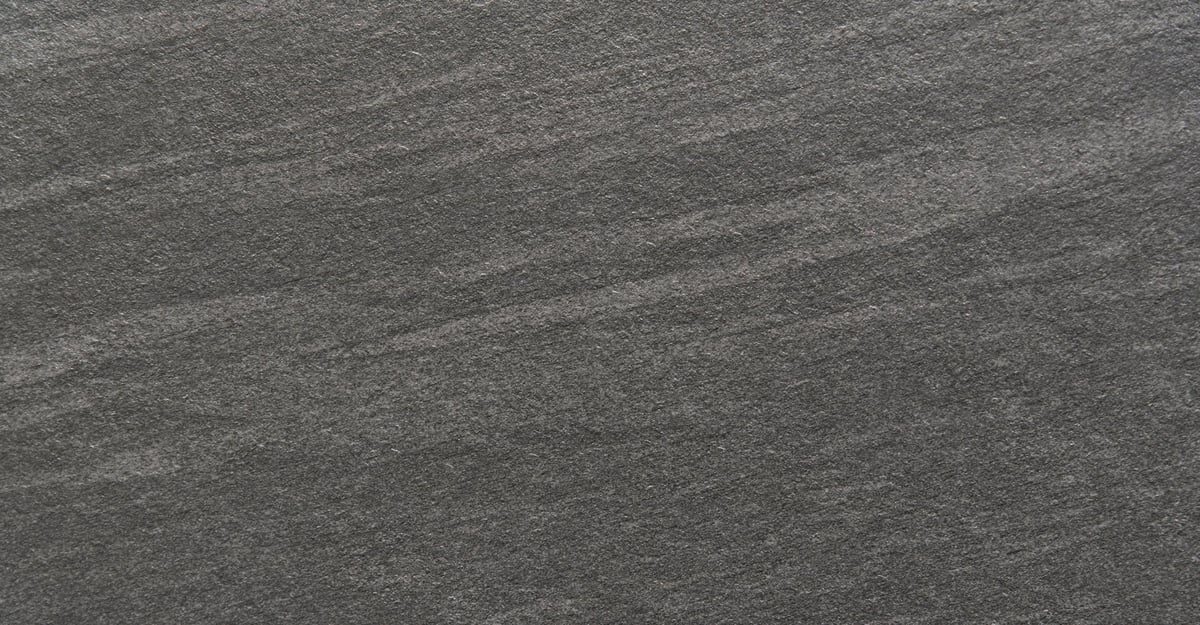 Dark structured natural soapstone surface with subtle veining