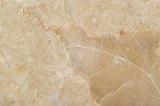 Marble surface with circular scratch patterns and natural veins