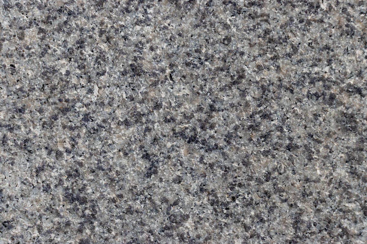 Premium grey granite stone surface with natural speckled mineral grains