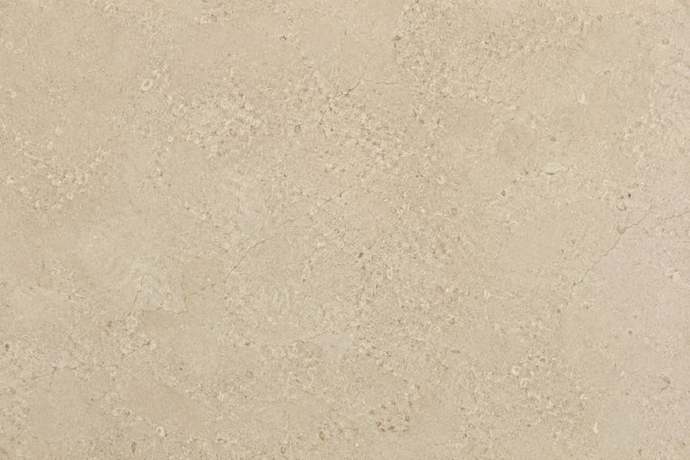 Close-up of beige and tan textured surface with granular speckled appearance, resembling stone or aggregate material