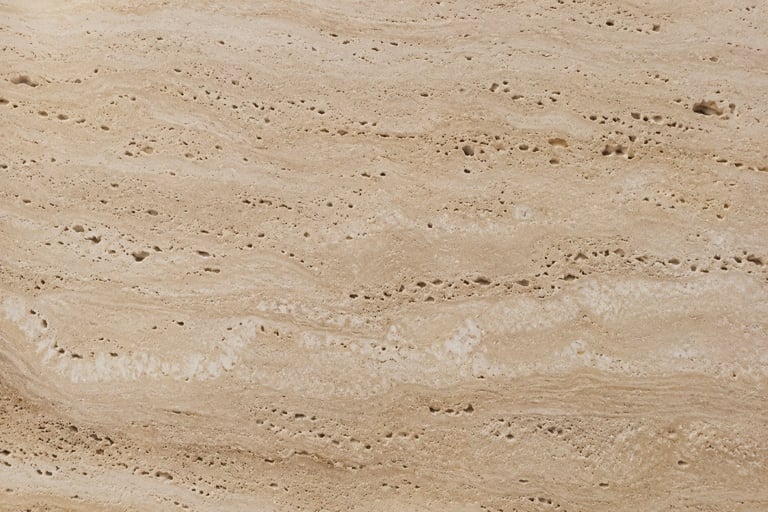 Close-up of sandy desert surface with scattered rocks and pebbles
