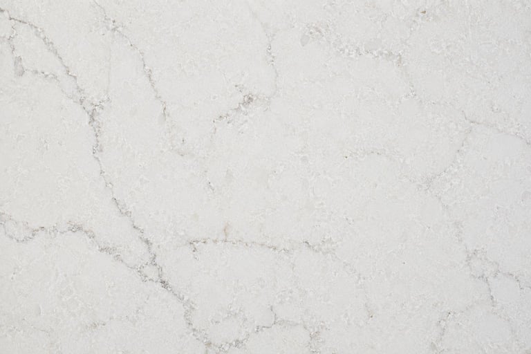 Close-up of white marble surface with gray veining and natural texture patterns