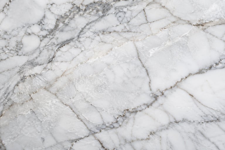 Close-up of white marble surface with natural gray and black veining patterns